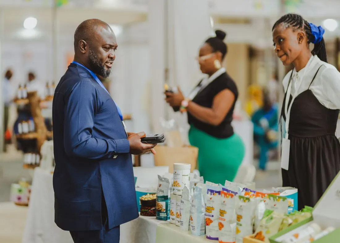 Business people talking at a trade show stand